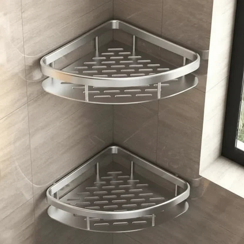 Two silver triangular corner shelves with slotted bases stacked on a beige tiled shower wall 21