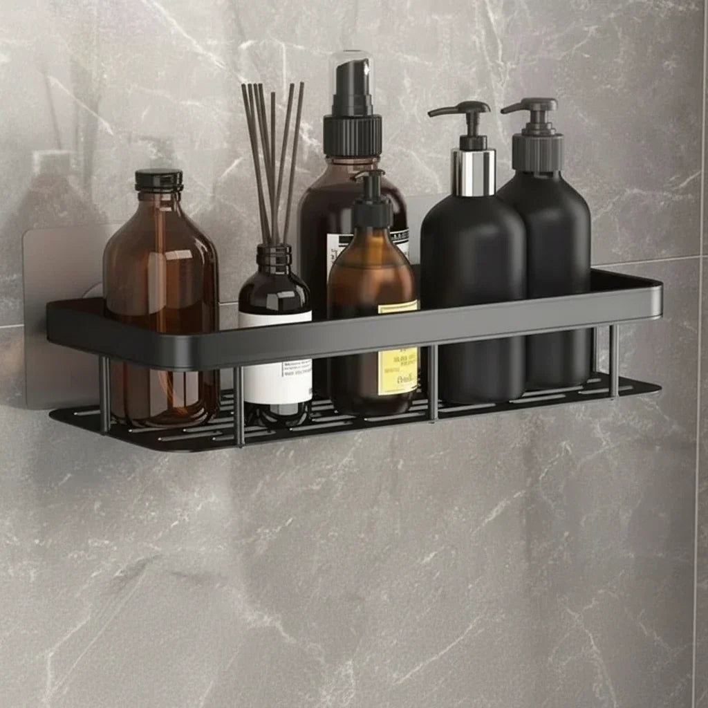Silver-toned shelf on white marble-effect wall holding white skincare tubes and bottles 6