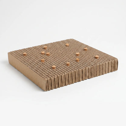Corrugated cardboard platform seen at an angle, with small cork stoppers pushed into the layered top surface, on a plain white background. 1
