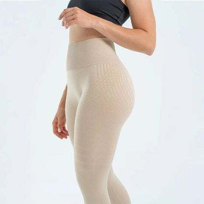 Side view of a model wearing cream high-waisted seamless leggings with a wide ribbed waistband and woven stripe detail. 2