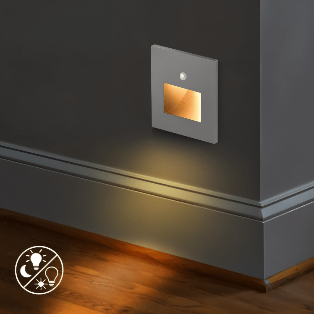 Grey square wall light with sensor and glowing window, lighting a skirting board and wooden floor 5