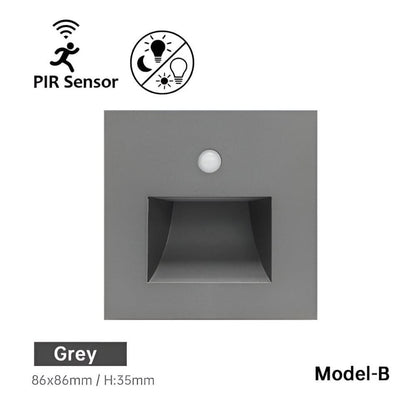 Front of the grey square wall light with a round sensor and a recessed light window 7