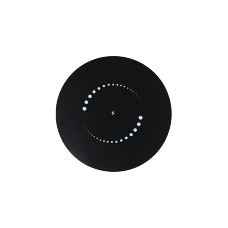 Top view of the black round charging surface, with a small lightning symbol in the centre ringed by two arcs of white dots. 10