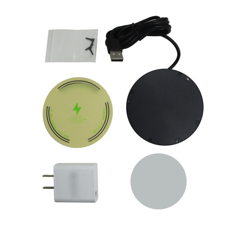 Flat lay of the box contents: charger, USB cable, white plug adapter, green alignment sticker, grey adhesive disc and a bag of screws. 13