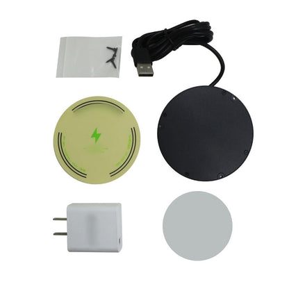 Flat lay of the box contents: charger, USB cable, white plug adapter, green alignment sticker, grey adhesive disc and a bag of screws. 13