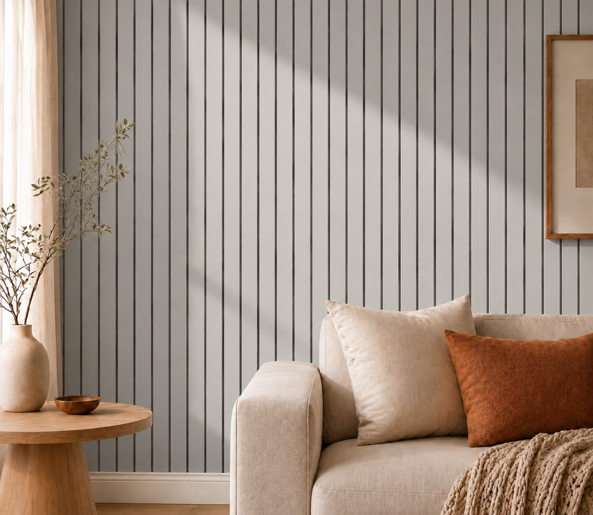 Grey slat wall in a living room beside a sofa, cushions and round side table 16