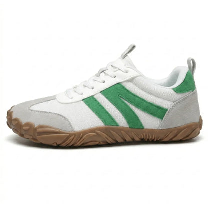 Side view of the white mesh shoe with green suede stripes, grey toe cap and heel, and tan gum sole. 28