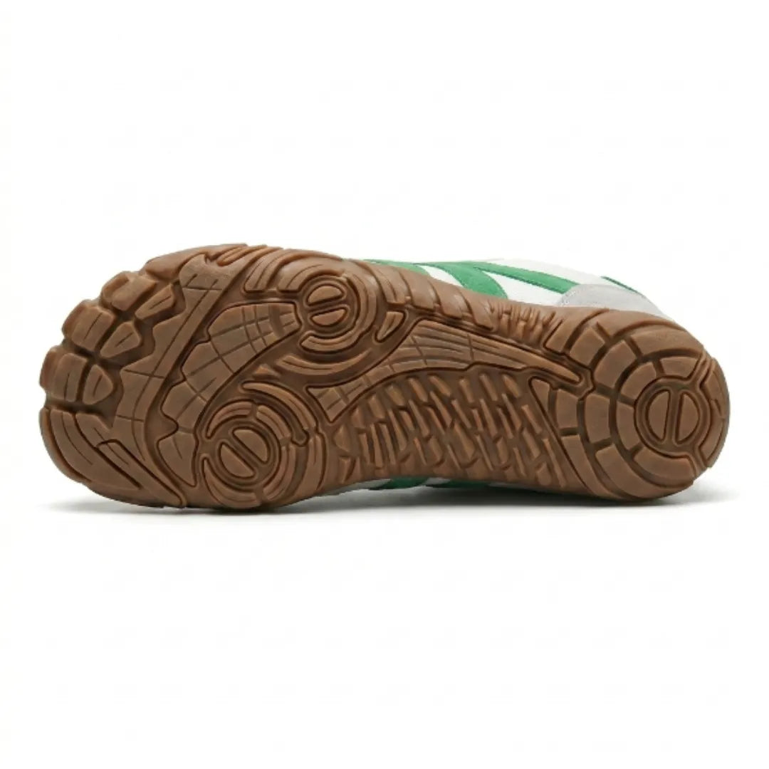 Underside of the white and green shoe showing the tan rubber outsole with its detailed tread pattern. 36
