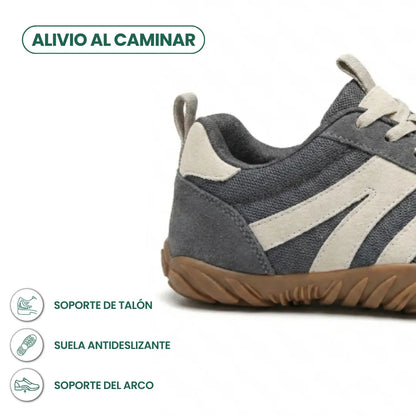 Close-up of the grey shoe's heel, with icons highlighting heel support, a grippy non-slip sole and arch support. 4