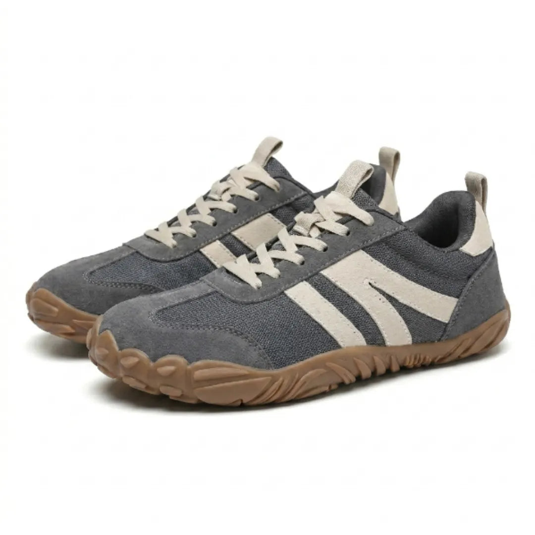 Pair of grey mesh and suede barefoot shoes seen at an angle, with cream stripes, cream laces and tan soles. 7