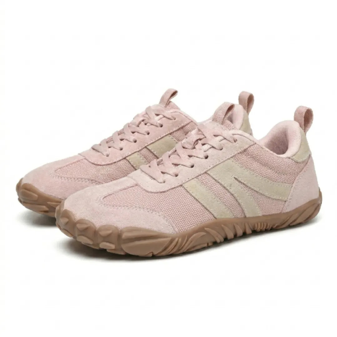 Pair of pink mesh and suede barefoot shoes seen at an angle, with beige stripes, pink laces and tan soles. 16