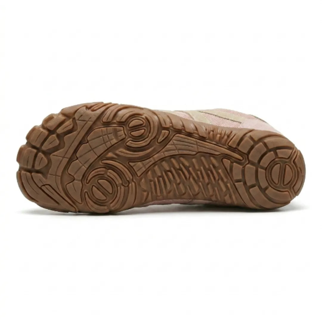 Underside of the pink shoe showing the tan rubber outsole with its deep multi-directional tread pattern. 18