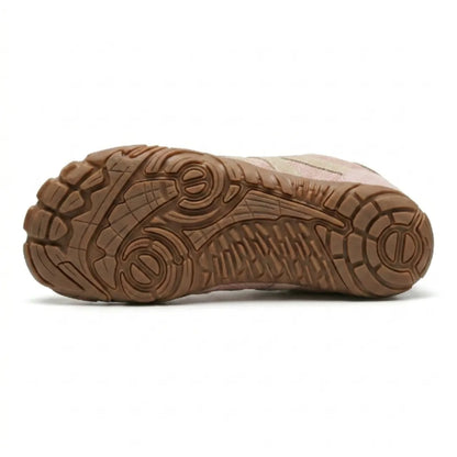 Underside of the pink shoe showing the tan rubber outsole with its deep multi-directional tread pattern. 18