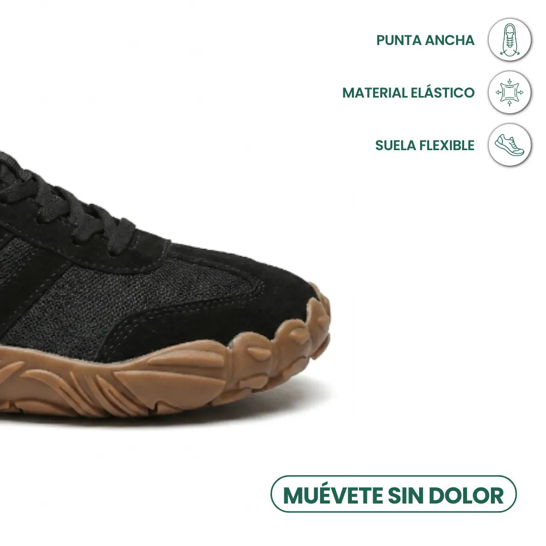 Close-up of the wide rounded toe of the black shoe with lacing, mesh panels and a gum sole, with feature icons. 23