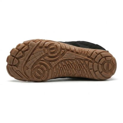 Underside of the black shoe showing the tan rubber outsole with its detailed tread pattern. 27