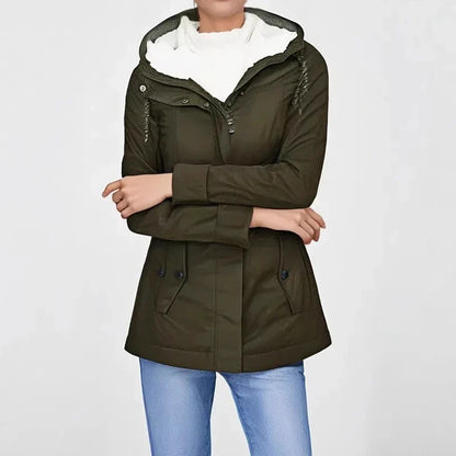 Model wearing the olive green jacket with arms folded, white fleece hood lining and jeans 1