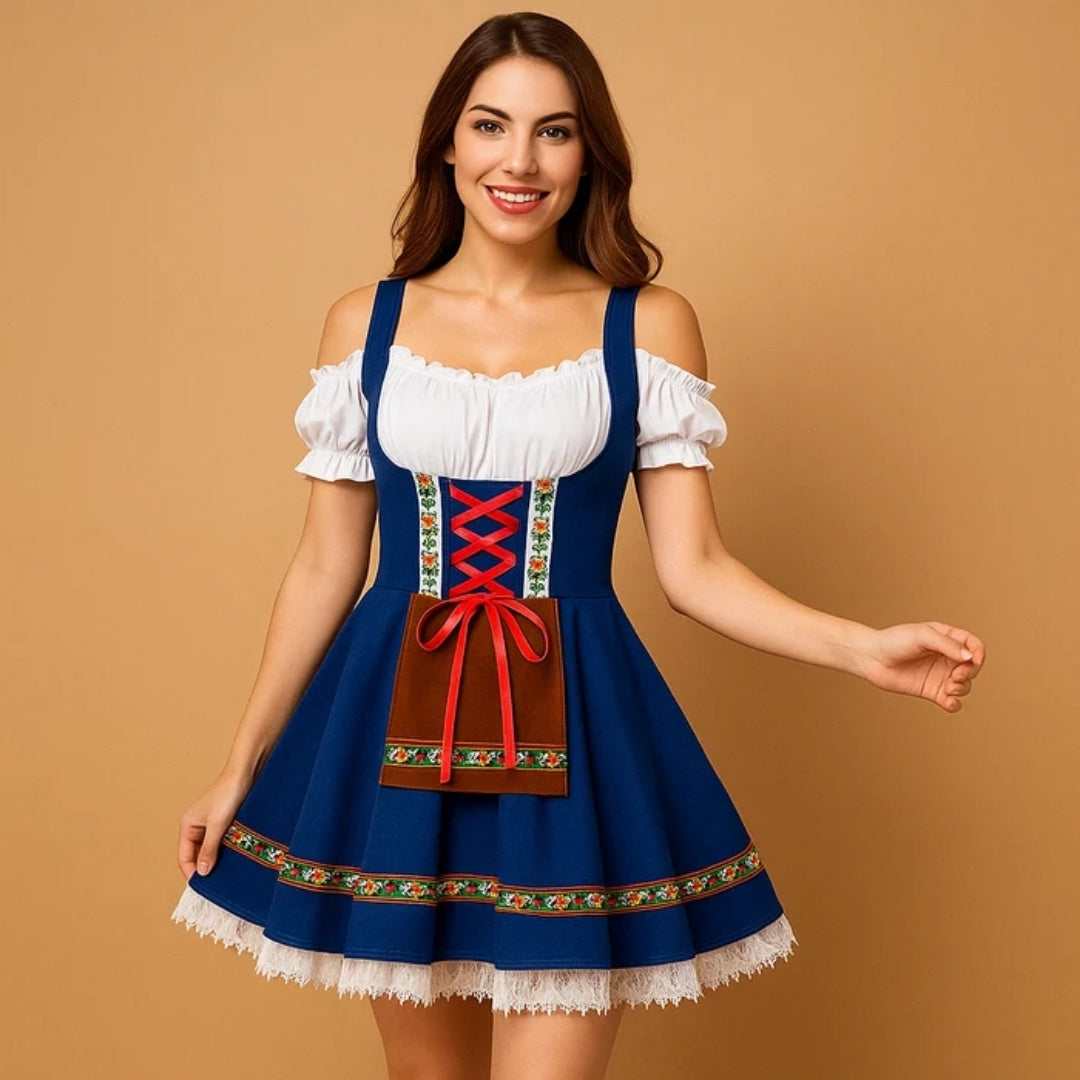 Smiling model holding her skirt in a royal blue dirndl with red lacing, brown apron panel and white lace hem. 4