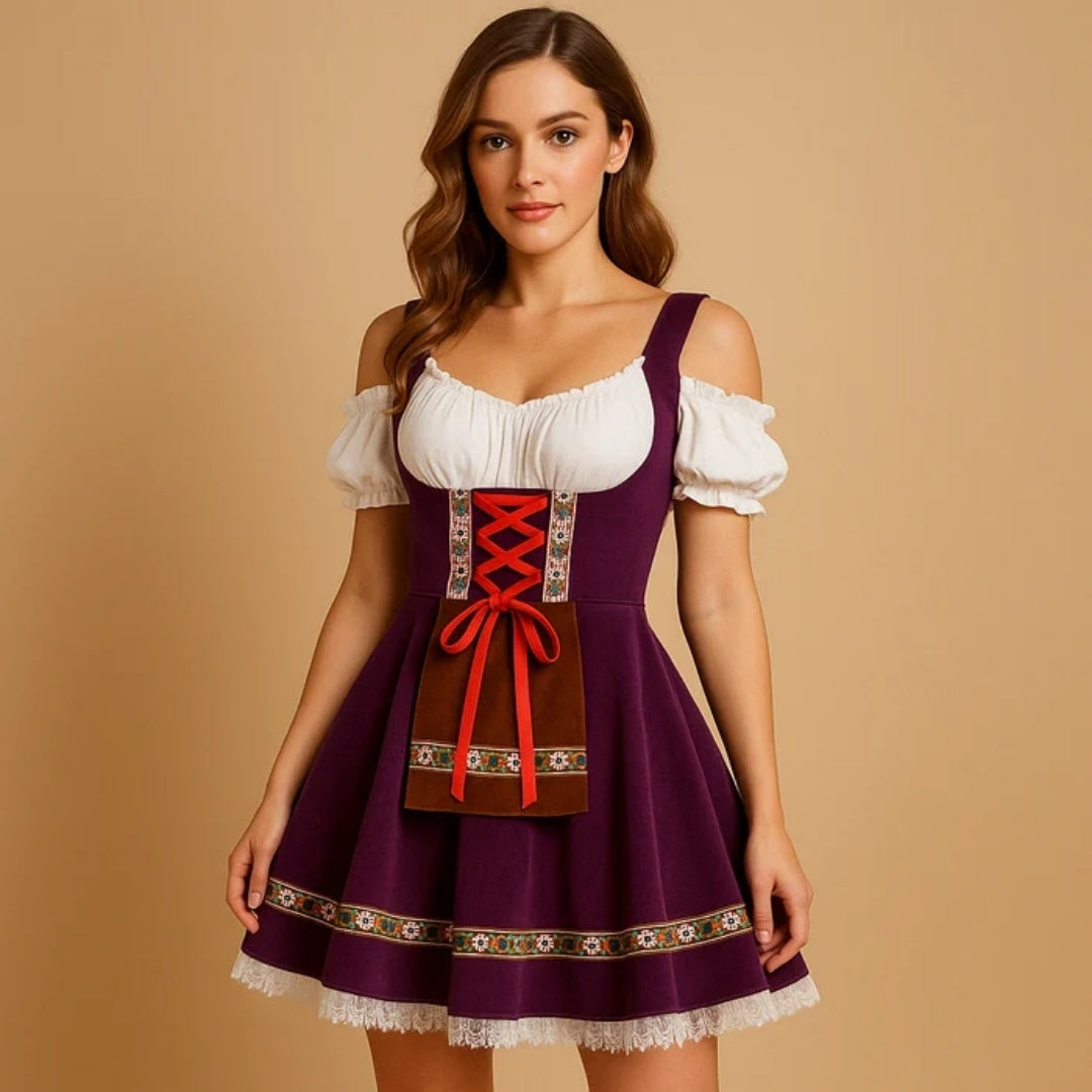 Model wearing a purple off-the-shoulder dirndl with red front lacing, brown pocket apron, floral trim and white lace hem. 2