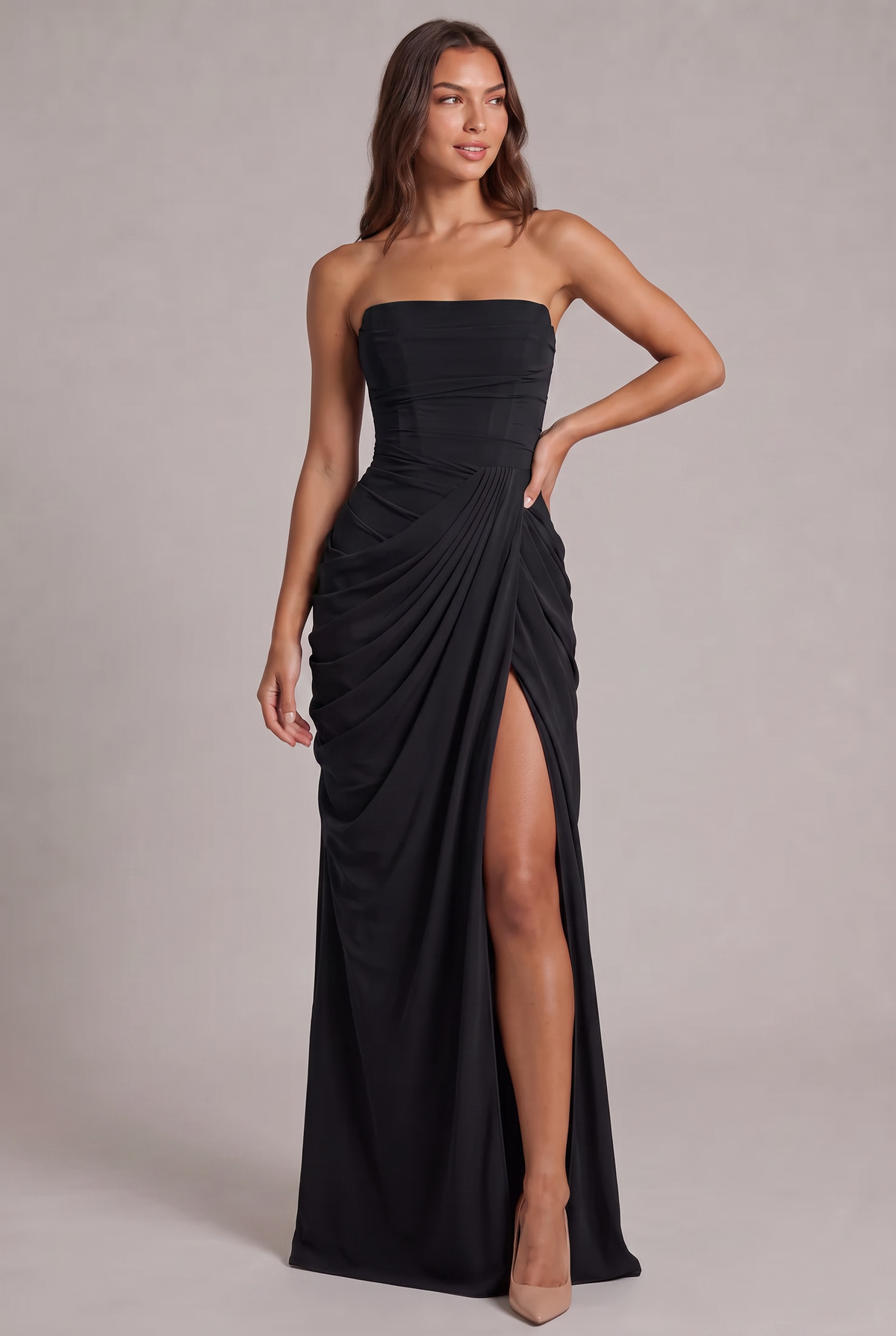 Model facing forward in the black strapless maxi dress, one hand on hip, slit showing 25