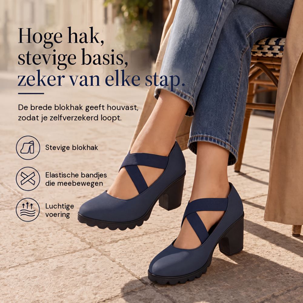 Navy block heels with crossed elastic straps worn by a seated woman in jeans and a trench coat on a paved street. 1