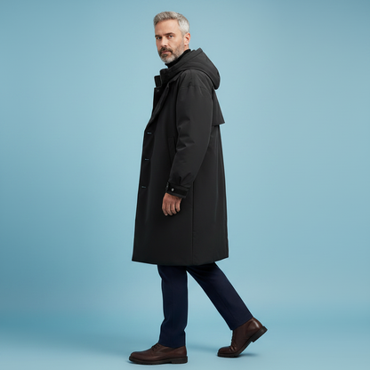 Side view of a model walking in the black hooded coat with brown leather shoes, showing the long length and hood. 6