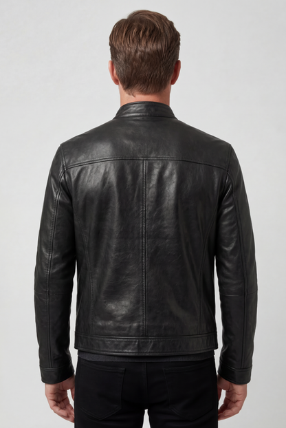 Back view of the black jacket on a model, showing the plain panelled back and stitched hem band 2