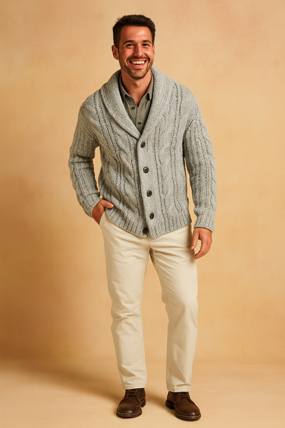 Full-length view of the light grey cardigan worn open-collared over an olive shirt with cream trousers and brown leather boots. 8