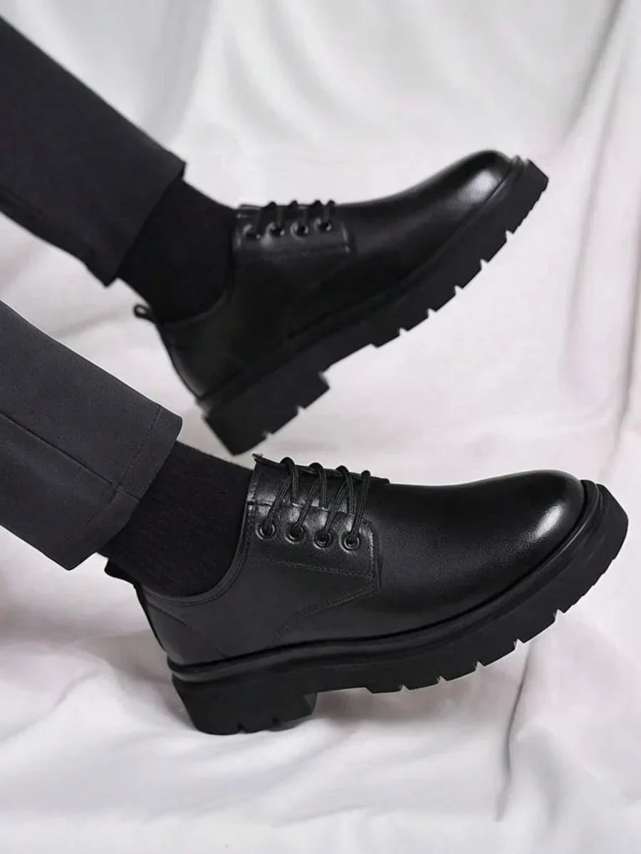 Worn derbies with feet raised, showing the deep treaded sole from the side 2