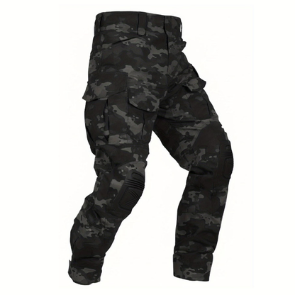 Flat view of the trousers in a black and grey camouflage pattern with black knee pads and flap cargo pockets. 14
