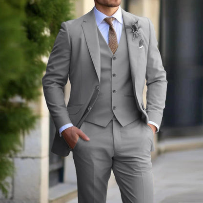 Model wearing the light grey version of the three-piece suit with white shirt and brown patterned tie 3