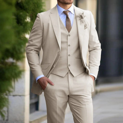 Model in a beige three-piece suit with light blue shirt, brown tie and floral lapel pin 1