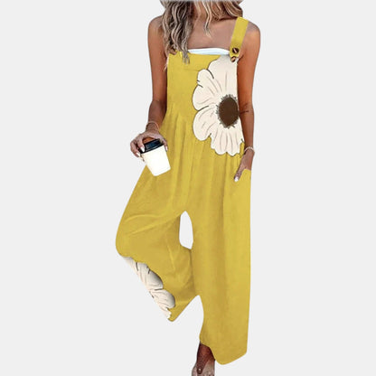 Model in yellow wide-leg dungarees with a large cream flower print, holding a coffee cup 9
