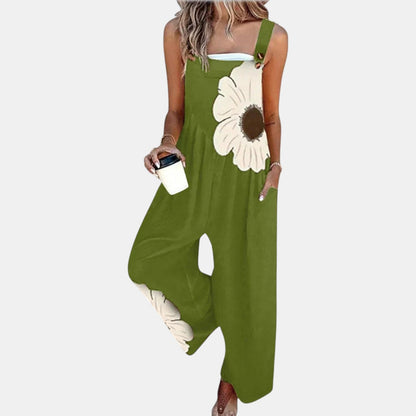 Model in green wide-leg dungarees with a large cream flower print, holding a coffee cup 10
