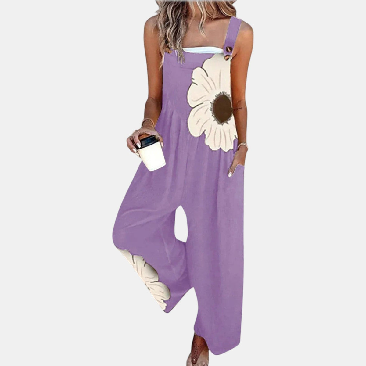 Model in lilac wide-leg dungarees with a large cream flower print, holding a coffee cup 8
