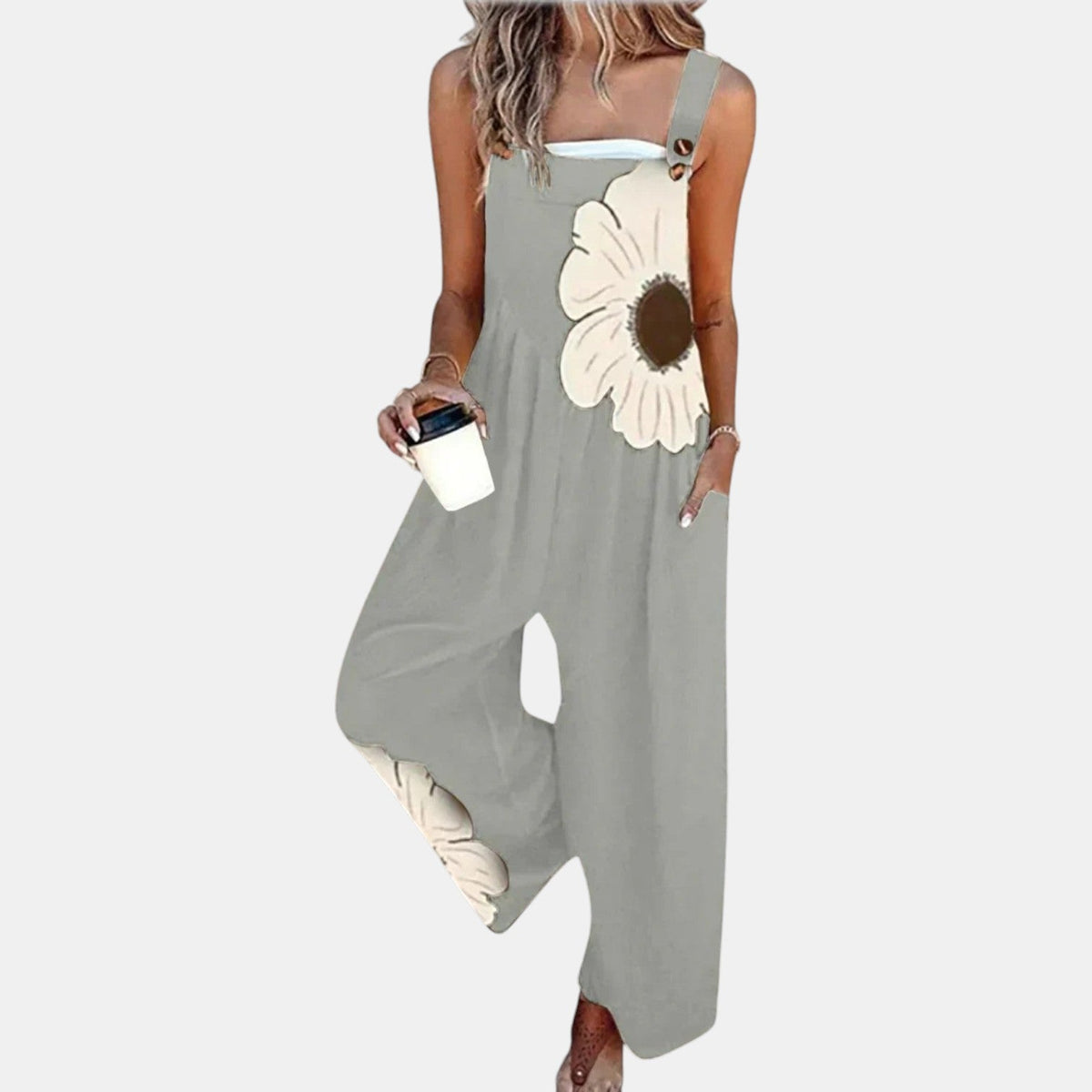 Model in grey wide-leg dungarees with a large cream flower print, holding a coffee cup 11