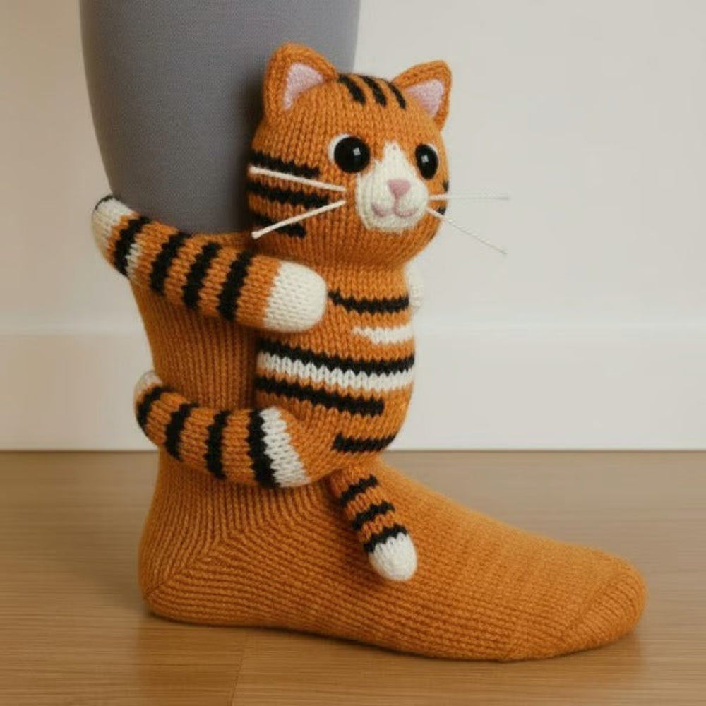 Orange knitted sock with a striped tabby cat figure clinging to the ankle 3
