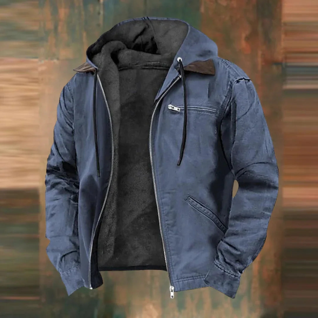 Slate blue version of the hooded jacket, open at the front with dark fleece lining, against a blurred rusty brown backdrop. 2