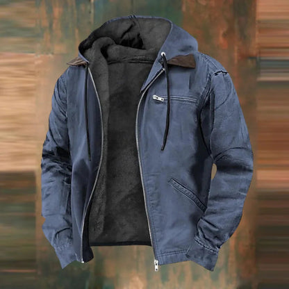Slate blue version of the hooded jacket, open at the front with dark fleece lining, against a blurred rusty brown backdrop. 2