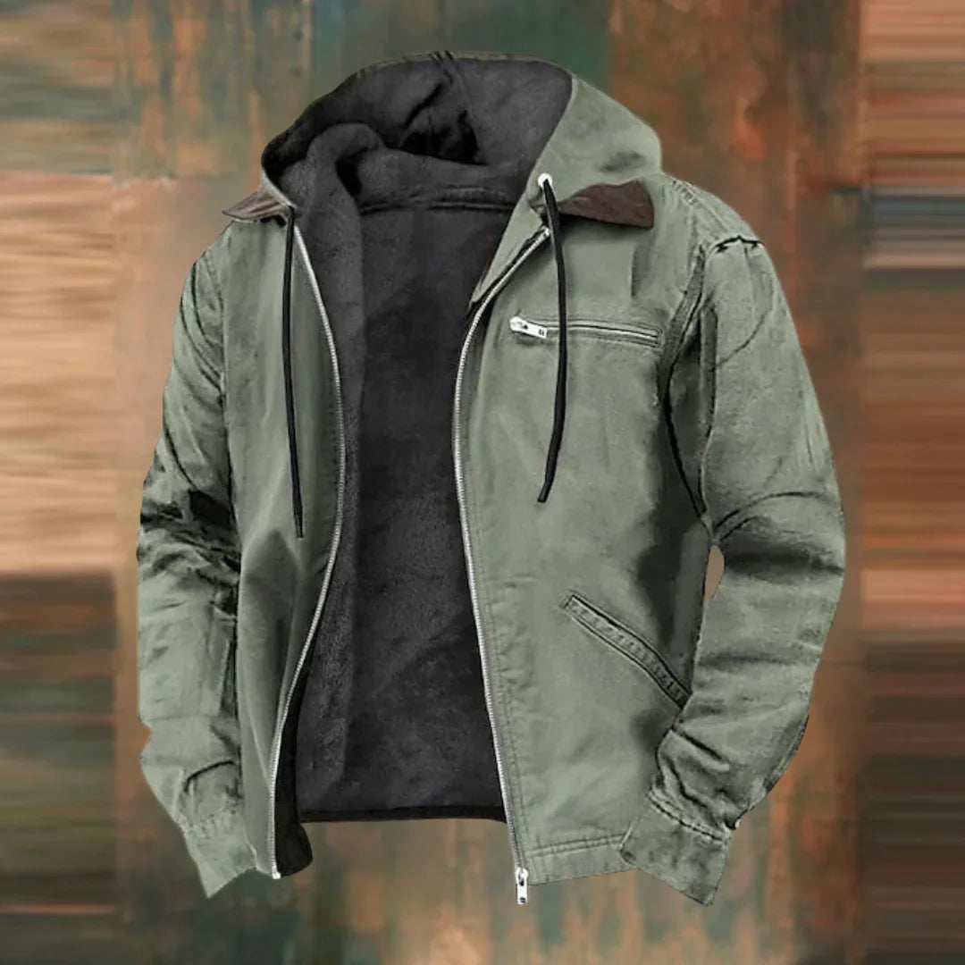 Sage green version of the hooded jacket, unzipped to reveal the dark fleece lining, shown against a blurred earthy backdrop. 3