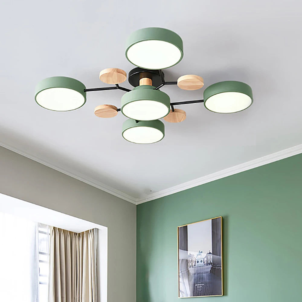 Green five-shade ceiling light with black arms and wooden discs, mounted on a white ceiling beside a green painted wall. 4