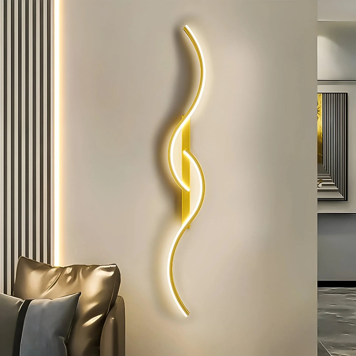 Gold wavy wall light glowing beside a cream wall and a leather sofa 1