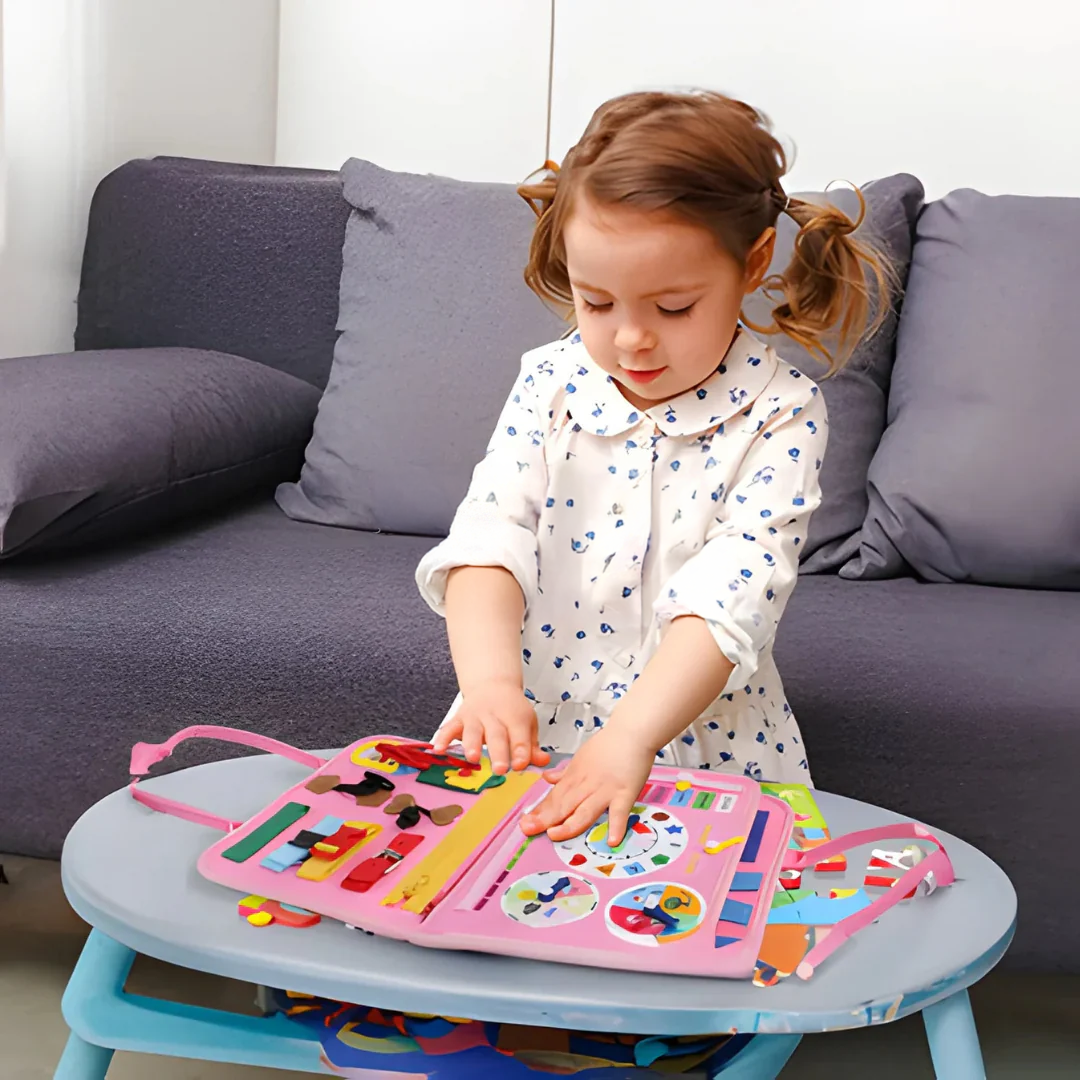Little girl in a floral dress touches the clock page of the pink book on a small table 5