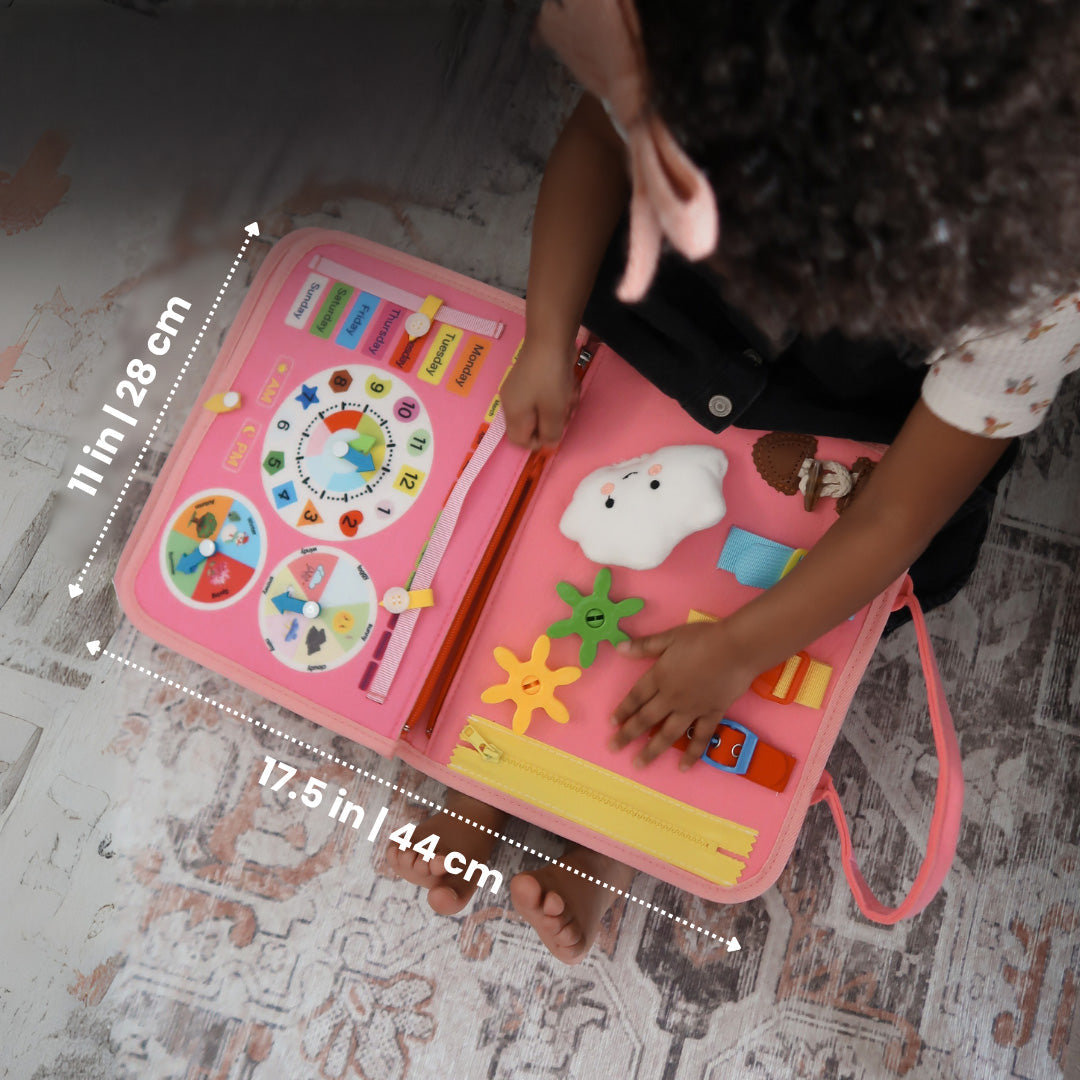 Overhead view of a child using the open pink book, with width and height dimensions marked 8