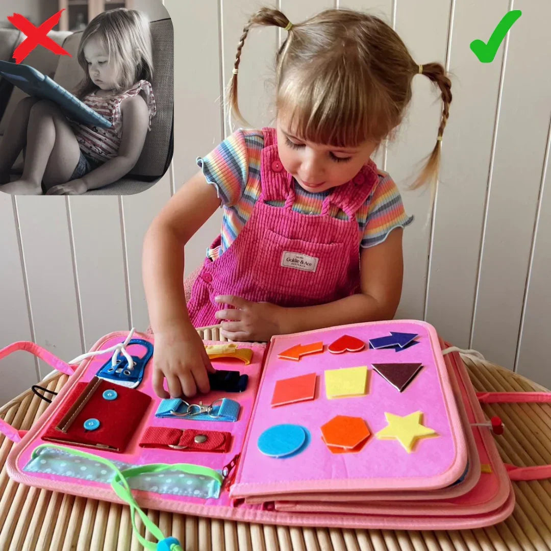 Girl with plaits in pink dungarees plays with the pink book, open at the felt shapes page 4