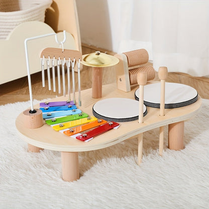 Side view of the music table standing on its round wooden legs on a fluffy white rug, with chimes, cymbal and mallets. 6