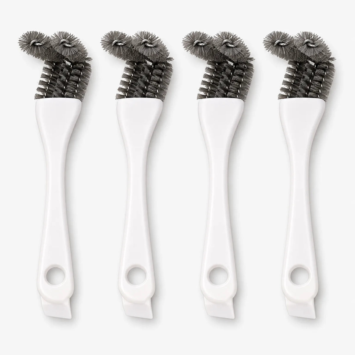 Four white-handled cage brushes standing upright side by side, each with a hanging hole and angled grey bristle heads. 1