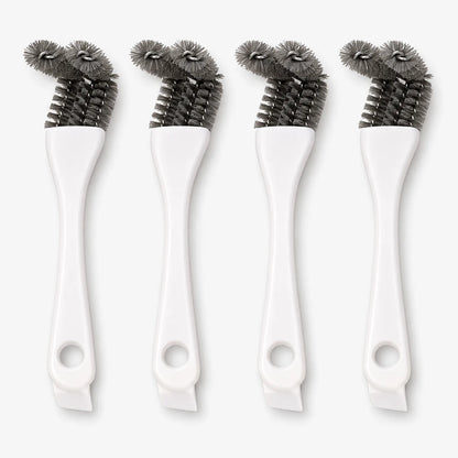 Four white-handled cage brushes standing upright side by side, each with a hanging hole and angled grey bristle heads. 1
