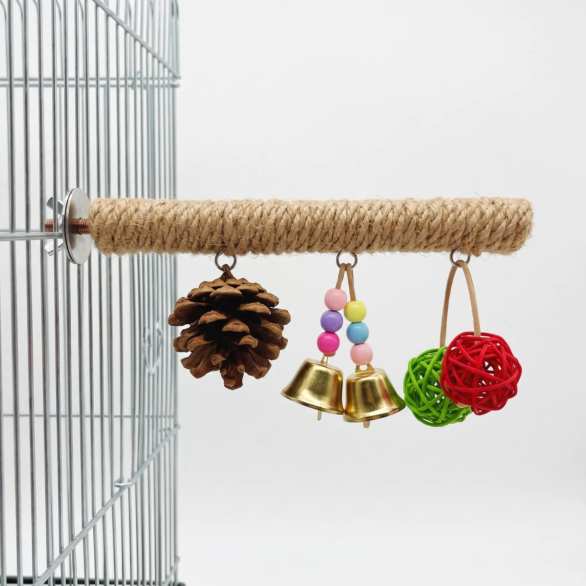 Rope-wrapped perch bolted to a wire cage, hung with a pine cone, two brass bells with coloured beads and two woven balls. 1