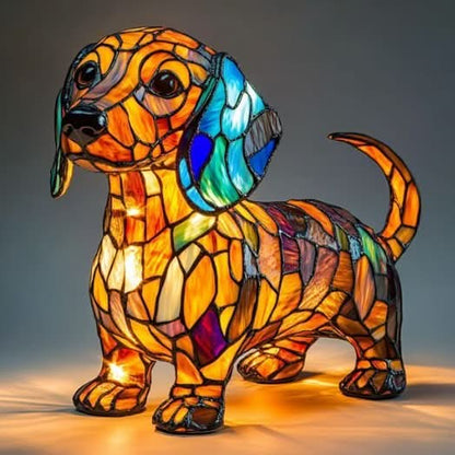 Standing dachshund lamp with a blue and green ear and curved tail, glowing orange with light pooling on the surface below. 11