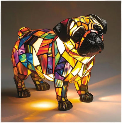 Standing pug lamp with black muzzle and ears, bold orange, purple, blue and yellow body panels, casting warm light on the surface. 20
